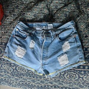 Vintage Levi's Light Blue Distressed Jean Shorts with yellow embroidered hem